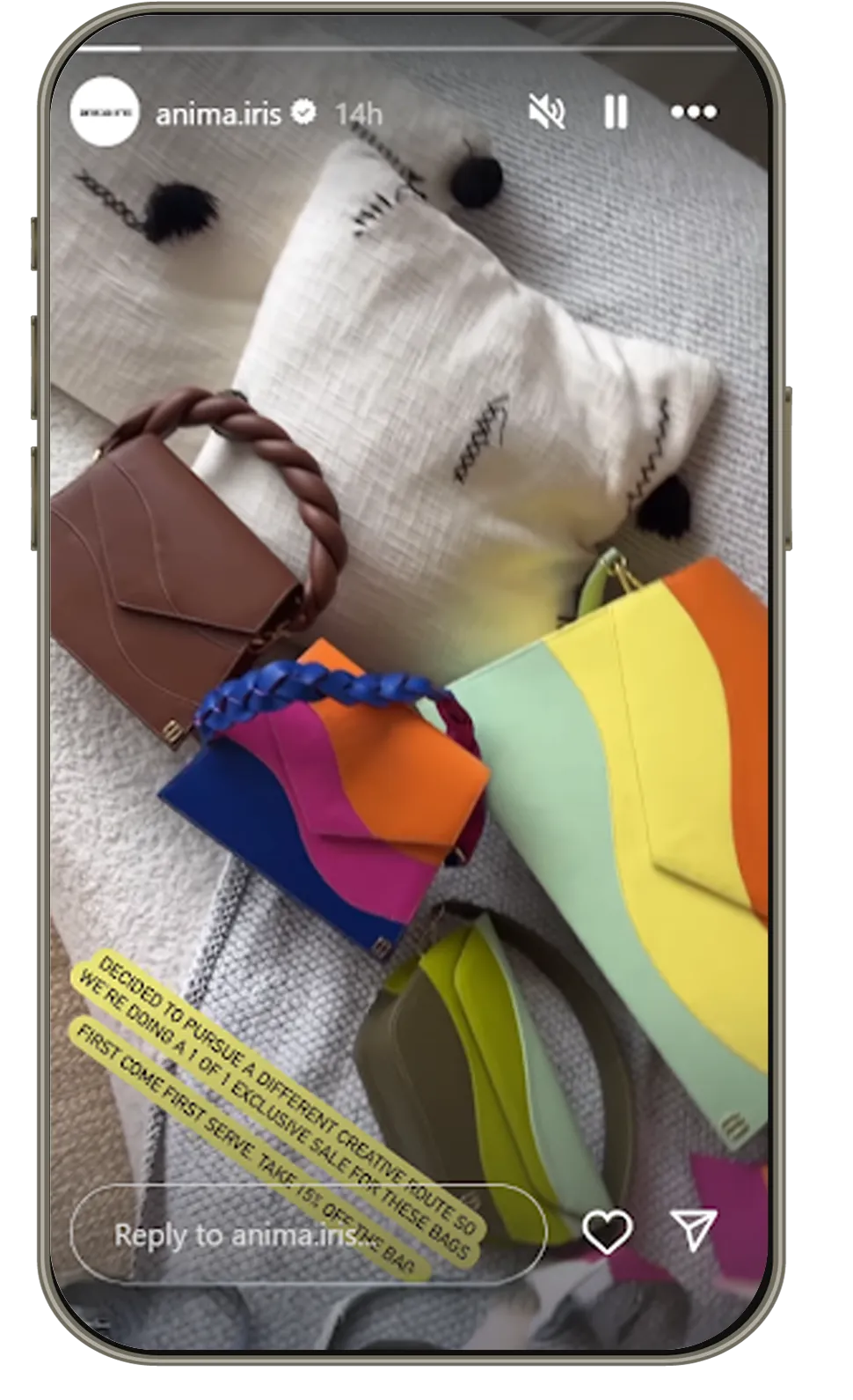 Colorful designer handbags by Anima Iris on a textured pillow with text about exclusive sale. Luxury fashion bags.