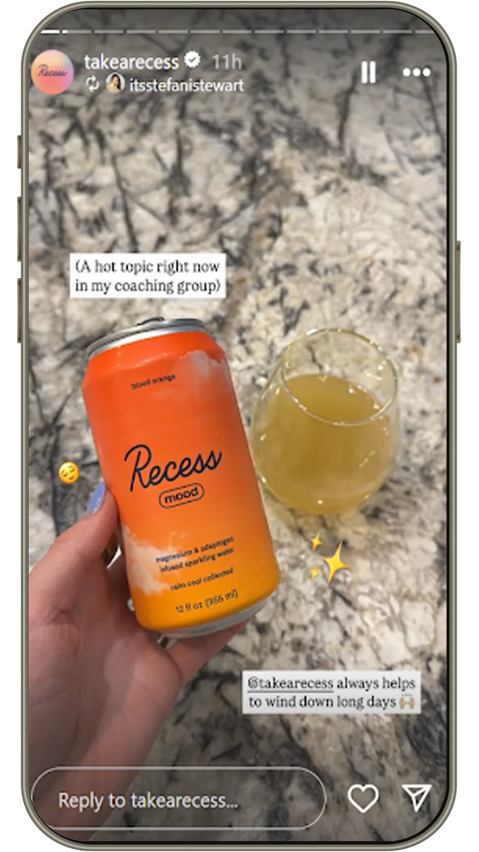Hand holding Recess mood blood orange sparkling water can beside a glass on a marble counter