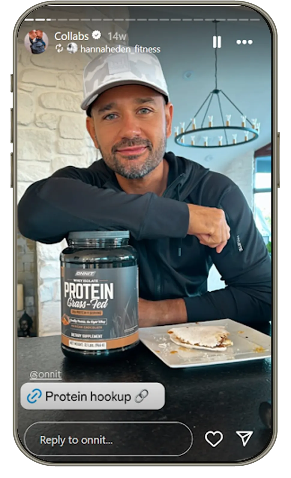 Man in casual wear sitting at table with Onnit grass-fed whey protein jar and sandwich. Protein supplement promotion